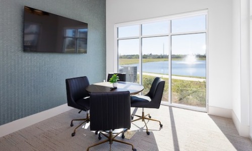 Private conference room with a lake view, perfect for remote work at these Kissimmee apartments.