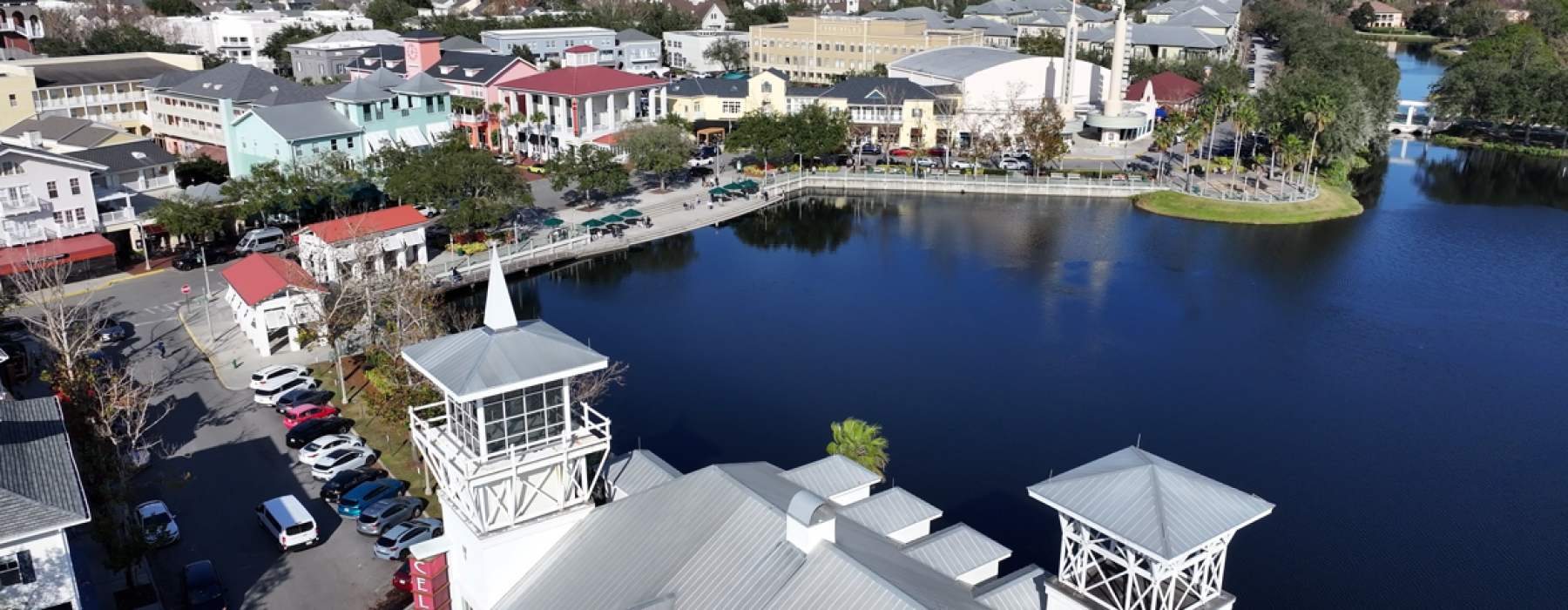 Aerial view of Celebration Florida downtown lakefront with shops and Celebration sign building