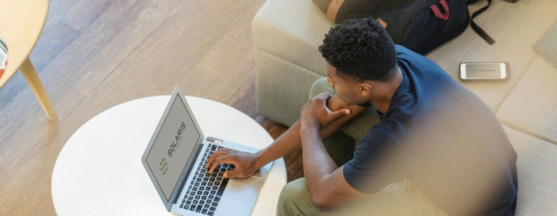 a person sitting on a couch using a laptop