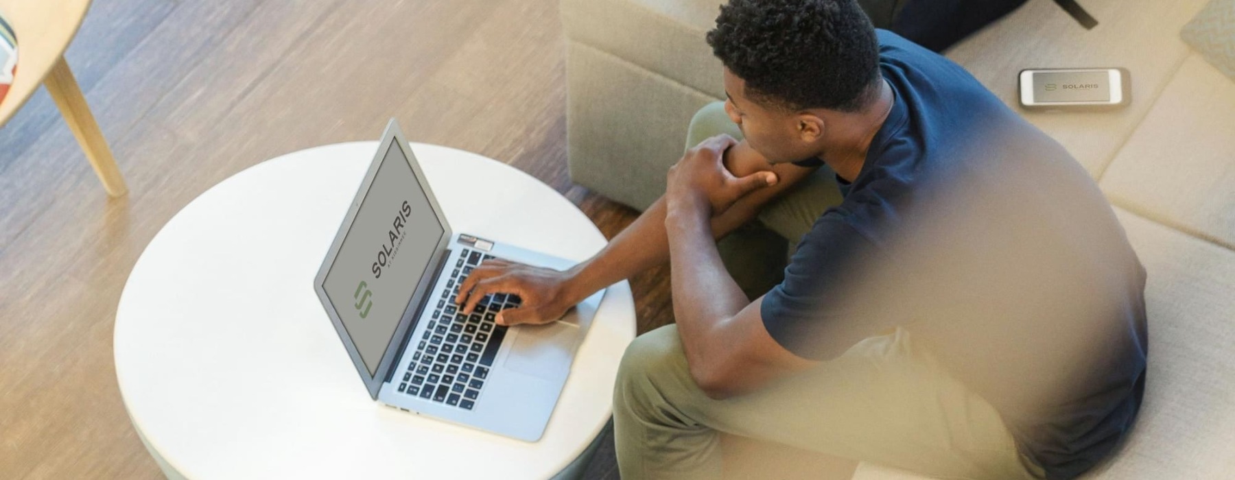 a person sitting on a couch using a laptop