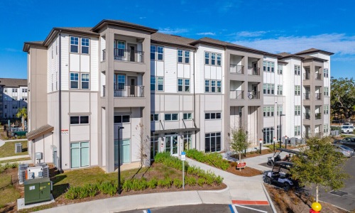 Exterior view of the modern apartment buildings and leasing office at Solaris at Kissimmee in Florida.