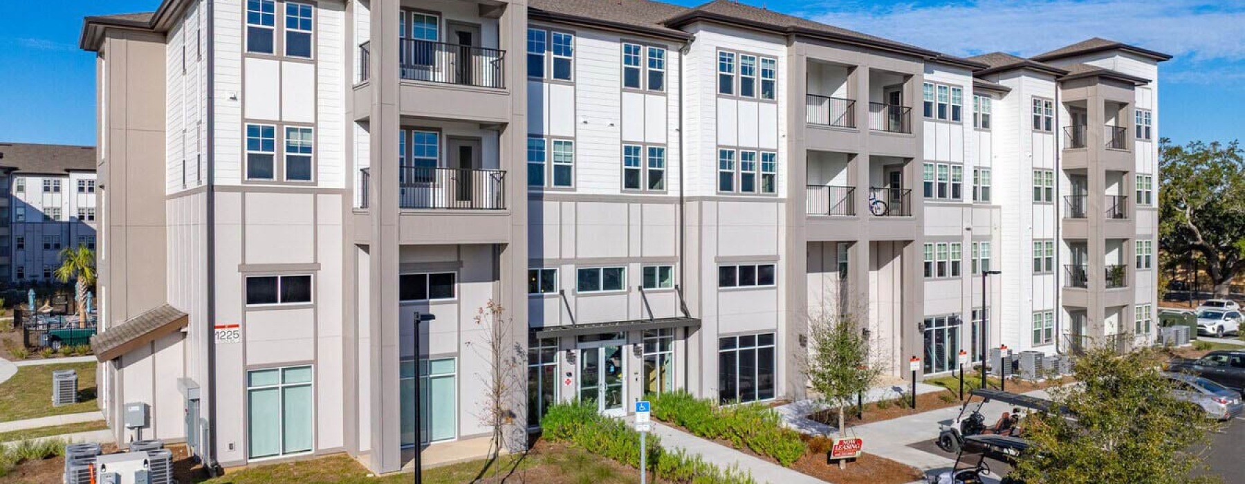 Exterior view of the modern apartment buildings and leasing office at Solaris at Kissimmee in Florida.