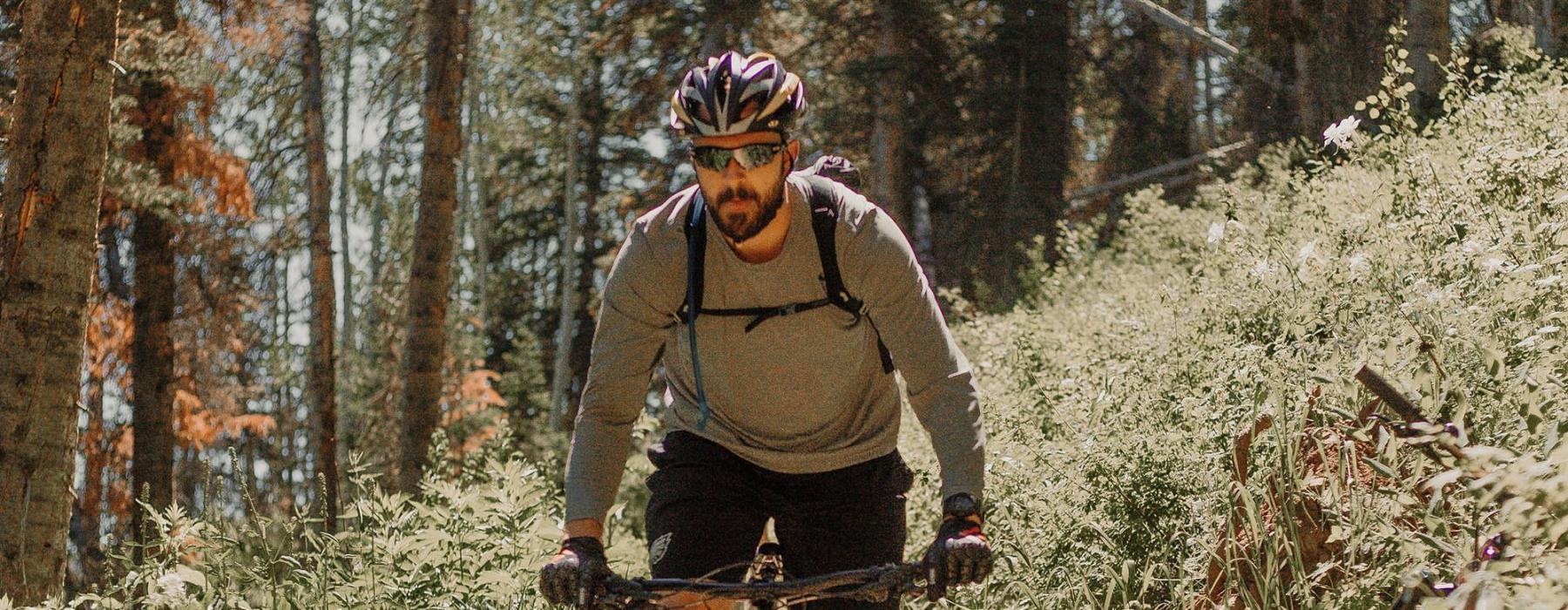 man riding a bike on a trail in the woods